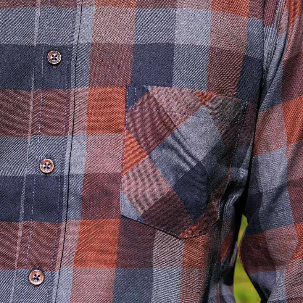 Close-up of a plaid shirt with a focus on the pattern and texture.